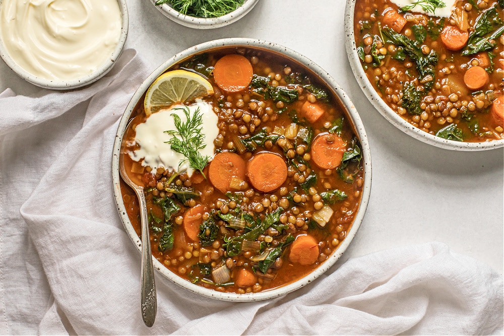 https://deliciouslyorganic.net/wp-content/uploads/2010/02/lentil-carrot-and-kale-soup-with-creme-fraiche-and-dill-1-1.jpg
