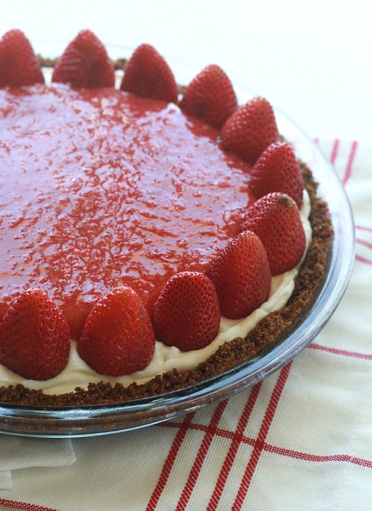 A graham cracker crust filled with sweet cheesecake and topped with strawberries makes for a delicious strawberry pie.