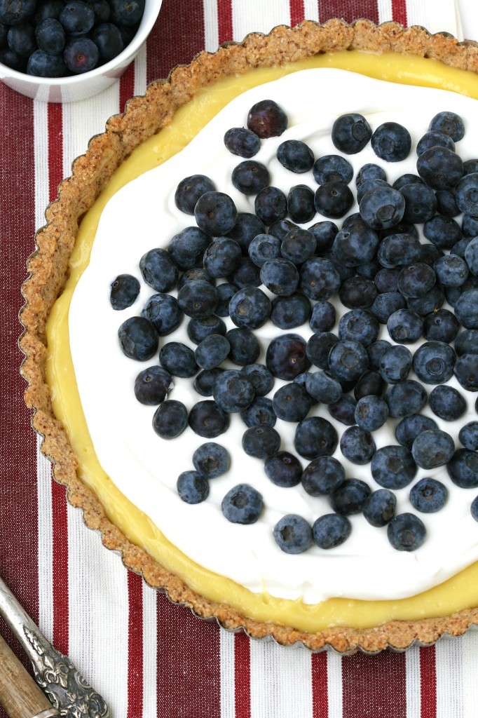 A grain-free lemon tart with a cookie-shortbread crust, whipped cream and berries sounds amazing!