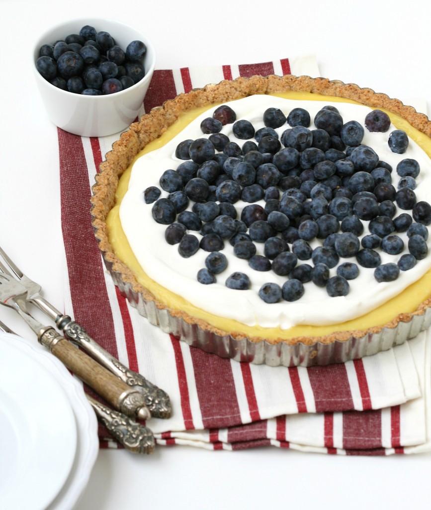 A grain-free lemon tart with a cookie-shortbread crust, whipped cream and berries sounds amazing!