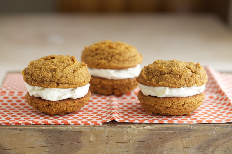 These pumpkin whoopie pies make for a great spongy cookie on their own - the cookies almost taste a bit like muffin tops. Two spiced cookies are paired together with whipped butter, cream cheese and maple syrup to sweeten. They are quite the treat.