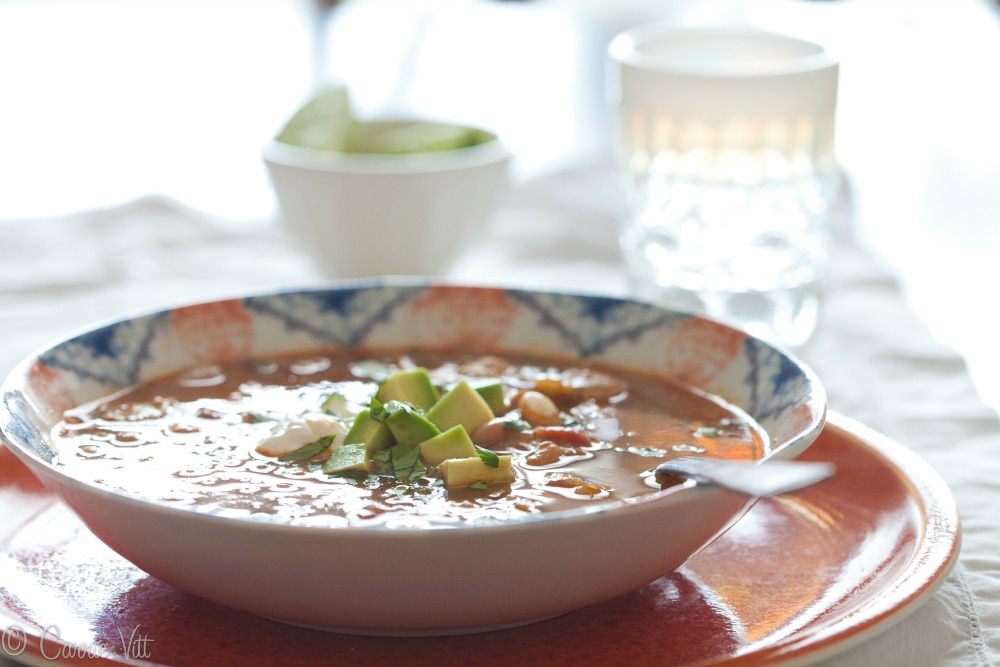 White Bean Chicken Chili is warm and comforting with lots of kick! It tastes even better the second day and you can get really creative with the toppings.