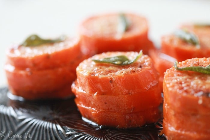 The sweet potato stacks are sliced, stacked in a muffin tin and drizzled with browned garlic and sage butter and topped with Parmigiano.