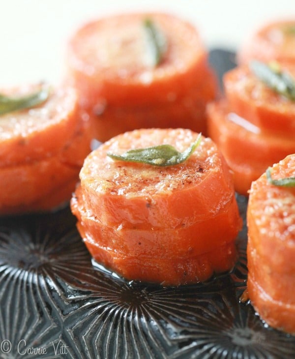 The sweet potato stacks are sliced, stacked in a muffin tin and drizzled with browned garlic and sage butter and topped with Parmigiano.