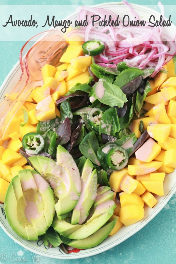 Cut the mango and avocado into bite-sized pieces, layer them with baby romaine, drizzle with jalapeño vinaigrette and top it all off with the pickled onions