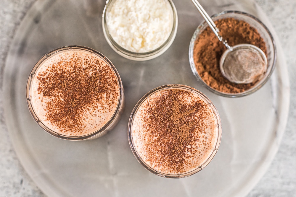 https://deliciouslyorganic.net/wp-content/uploads/2023/07/chocolate-cheesecake-protein-smoothie-2-1.jpg